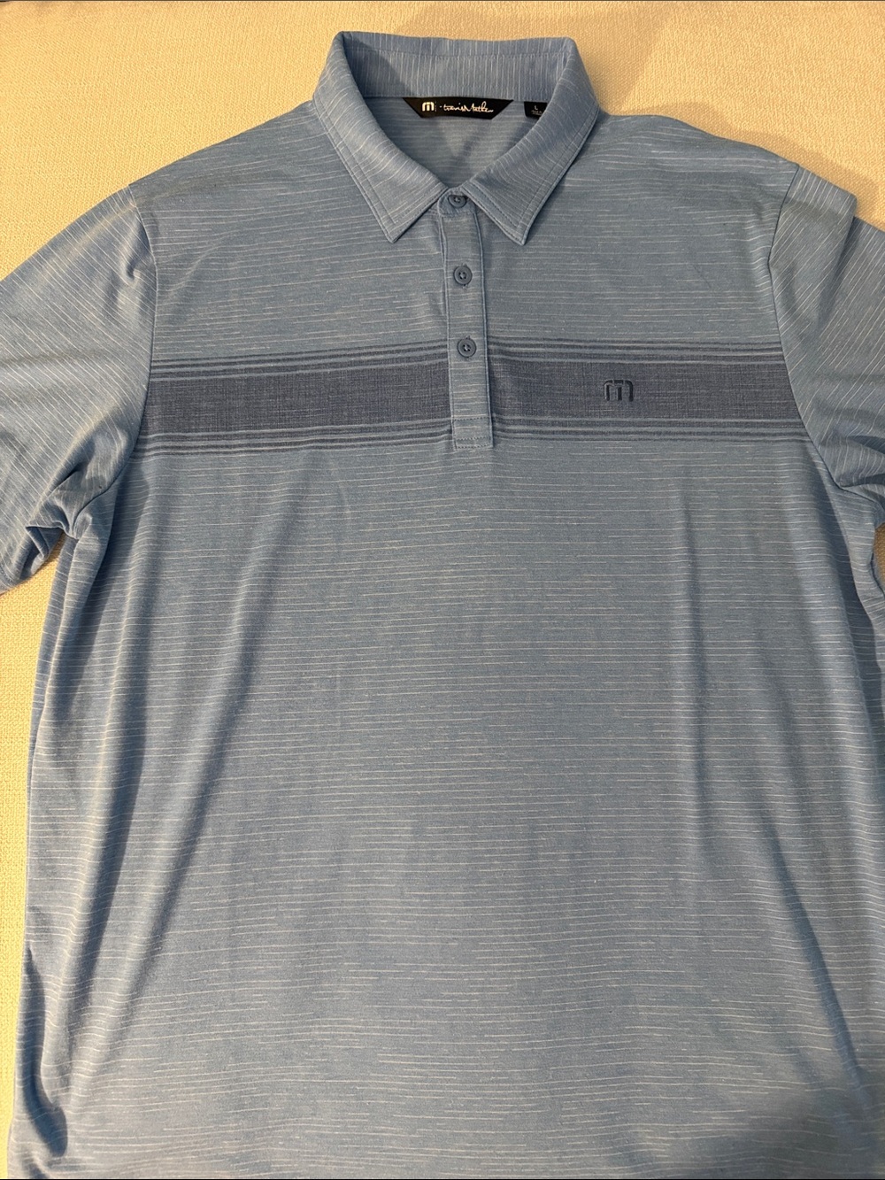 NWOT Travis Mathew Light Blue Heathered Polo with Navy Chest Stripe